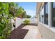 Backyard patio features decorative concrete and privacy fence with mature landscaping at 1065 Berg Ct, The Villages, FL 32162