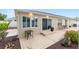 Backyard patio features decorative concrete and mature landscaping at 1065 Berg Ct, The Villages, FL 32162