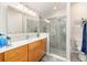 Modern bathroom featuring a glass shower, a sink and wood cabinets at 1065 Berg Ct, The Villages, FL 32162