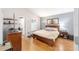 Relaxing primary bedroom with wood floors and blue accents at 1065 Berg Ct, The Villages, FL 32162