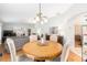 Open-concept dining area with views into the living room and featuring a stylish chandelier at 1065 Berg Ct, The Villages, FL 32162