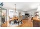 Charming dining area with a round wood table, four chairs, and sliding glass doors to the patio at 1065 Berg Ct, The Villages, FL 32162