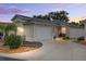 Charming single-story home featuring a well-manicured lawn, beautiful landscaping, and a two-car garage at 1065 Berg Ct, The Villages, FL 32162