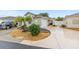 Charming single-story home featuring a well-manicured lawn, beautiful landscaping, and a two-car garage at 1065 Berg Ct, The Villages, FL 32162