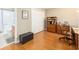 Comfortable home office features hard floors, wood furnishings, closet and adjacent full bathroom at 1065 Berg Ct, The Villages, FL 32162