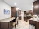 Spacious kitchen featuring dark wood cabinets, granite countertops, stainless steel appliances, and an island at 1065 Berg Ct, The Villages, FL 32162