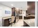 Spacious kitchen featuring dark wood cabinets, granite countertops, stainless steel appliances, and an island at 1065 Berg Ct, The Villages, FL 32162