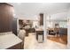 Modern kitchen with stainless steel appliances, granite countertops, tile flooring, and a view of the dining area at 1065 Berg Ct, The Villages, FL 32162