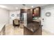 Spacious kitchen featuring dark wood cabinets, granite countertops, stainless steel appliances, and a kitchen island at 1065 Berg Ct, The Villages, FL 32162