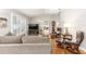 Bright living room with comfortable seating, wood floors, and plantation shutters at 1065 Berg Ct, The Villages, FL 32162