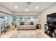 Cozy living room with tile floors, neutral paint and comfortable furniture at 1065 Berg Ct, The Villages, FL 32162