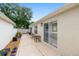 A covered patio features decorative concrete and mature landscaping at 1065 Berg Ct, The Villages, FL 32162