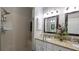 Bright bathroom featuring a glass shower and double sinks with granite counters at 1105 San Remo Ln, Lady Lake, FL 32159