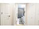 Hallway leading to a bathroom with a vanity, toilet, shower curtain, and marble floors at 1105 San Remo Ln, Lady Lake, FL 32159