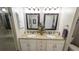 Bright bathroom featuring double sinks with granite counters and decorative mirrors at 1105 San Remo Ln, Lady Lake, FL 32159