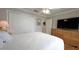 Bedroom with hardwood floors, ceiling fan, closet, and a dresser with a TV at 1105 San Remo Ln, Lady Lake, FL 32159