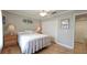 Bedroom features hardwood flooring, a ceiling fan, and a closet with mirrored doors at 1105 San Remo Ln, Lady Lake, FL 32159