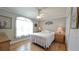 Bright bedroom with hardwood flooring, ceiling fan, and a large window with natural light at 1105 San Remo Ln, Lady Lake, FL 32159