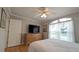 Well-lit bedroom featuring a large window, hardwood floors, and a ceiling fan at 1105 San Remo Ln, Lady Lake, FL 32159