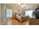 Spacious bedroom featuring hardwood floors, a ceiling fan, and two large windows at 1105 San Remo Ln, Lady Lake, FL 32159