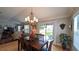 Dining room with natural light adjacent to the living room and access to the yard at 1105 San Remo Ln, Lady Lake, FL 32159