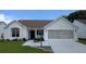Charming home featuring a well-manicured lawn and a convenient two-car garage at 1105 San Remo Ln, Lady Lake, FL 32159