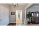 Elegant foyer featuring stone floors, chandelier, and views into the bathroom at 1105 San Remo Ln, Lady Lake, FL 32159