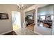 Elegant foyer featuring stone floors, chandelier, and views into the living spaces and bathroom at 1105 San Remo Ln, Lady Lake, FL 32159