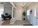 Elegant foyer featuring stone floors, chandelier, and views into the living spaces at 1105 San Remo Ln, Lady Lake, FL 32159