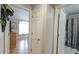 Hallway leading to a bedroom with hardwood floors and a bathroom with a shower and tub at 1105 San Remo Ln, Lady Lake, FL 32159