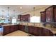 Spacious kitchen with stainless steel appliances, granite counters, tiled backsplash and wood cabinets at 1105 San Remo Ln, Lady Lake, FL 32159