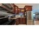 The beautiful kitchen features stainless appliances, wood cabinets and view to the living area at 1105 San Remo Ln, Lady Lake, FL 32159