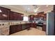 Spacious kitchen features granite counters, tiled backsplash, stainless steel appliances, and wood cabinetry at 1105 San Remo Ln, Lady Lake, FL 32159