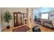 Bright Living Room with hardwood floors, display cabinet, and entry to the adjacent room at 1105 San Remo Ln, Lady Lake, FL 32159