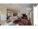 Bright living room featuring hardwood floors, an area rug, television, and access to the office at 1105 San Remo Ln, Lady Lake, FL 32159