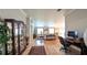 Bright living room with hardwood floors, area rug, and an open floor plan to the rest of the home at 1105 San Remo Ln, Lady Lake, FL 32159
