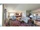 Open living room featuring hardwood floors and easy access to the kitchen and entry way at 1105 San Remo Ln, Lady Lake, FL 32159