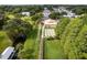 Aerial view of community clubhouse with a walking bridge amid lush greenery at 11926 Milan Way, Leesburg, FL 34788