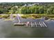 Aerial view showcasing the lake, beach, boat dock, and pier in the community at 11926 Milan Way, Leesburg, FL 34788