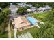 Overhead of community pool, clubhouse, and parking with shuffleboard courts at 11926 Milan Way, Leesburg, FL 34788