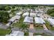 Community aerial view with well-maintained homes, a covered carport, Florida rooms, and landscaping at 11926 Milan Way, Leesburg, FL 34788