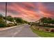 Community entrance featuring lush landscaping and a dramatic sky at Lake Yale Estates at 11926 Milan Way, Leesburg, FL 34788