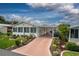 Charming home featuring a covered carport, Florida room, and well-maintained landscaping at 11926 Milan Way, Leesburg, FL 34788