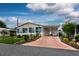 Charming home featuring a covered carport, Florida room, and well-maintained landscaping at 11926 Milan Way, Leesburg, FL 34788