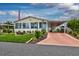 Charming home featuring a covered carport, Florida room, and well-maintained landscaping at 11926 Milan Way, Leesburg, FL 34788