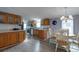 Charming kitchen with oak cabinets, dining nook, and modern appliances at 11926 Milan Way, Leesburg, FL 34788