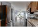 Bright, eat-in kitchen featuring stainless steel appliances, light countertops and modern flooring at 11926 Milan Way, Leesburg, FL 34788
