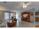 Inviting living room with stylish furniture and entertainment center, complemented by bright windows at 11926 Milan Way, Leesburg, FL 34788