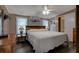Cozy main bedroom featuring a ceiling fan and ensuite bath at 11926 Milan Way, Leesburg, FL 34788