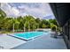 Community swimming pool with lounge chairs and nearby palm trees on a sunny day at 11926 Milan Way, Leesburg, FL 34788